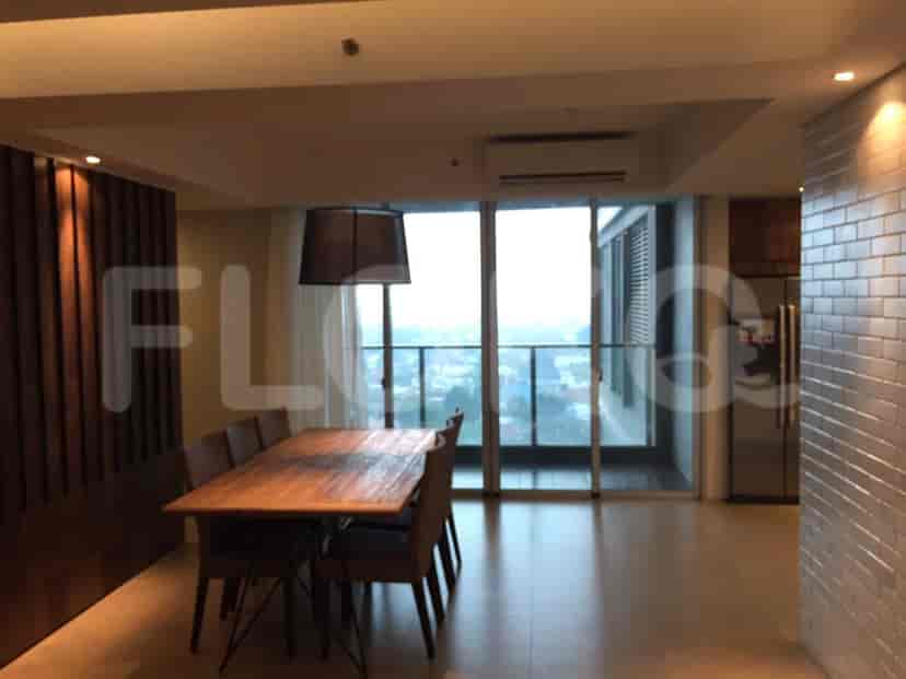 Bright living room and dining area with a dining set, curtained windows, and a kitchen access.