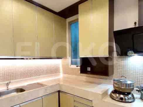 A bathroom with a bathtub, a shower, and beige tiles.