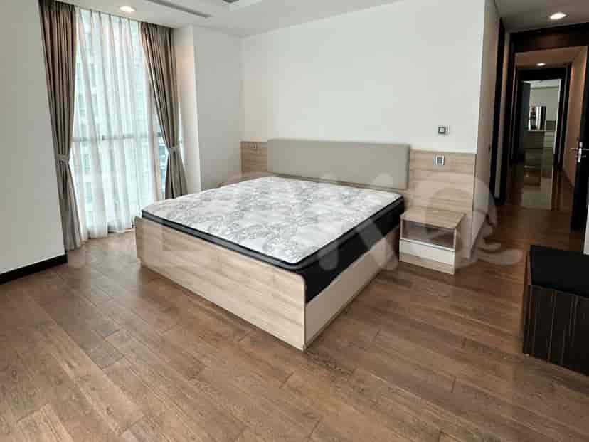 Bedroom with a king-size bed, a nightstand, and a balcony.