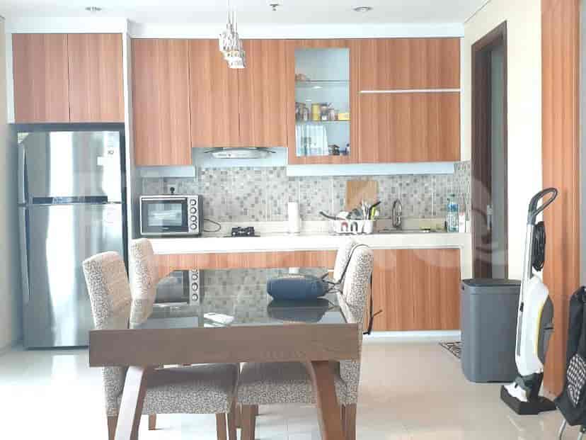 A modern kitchen and dining area with stainless steel appliances and wooden cabinets.