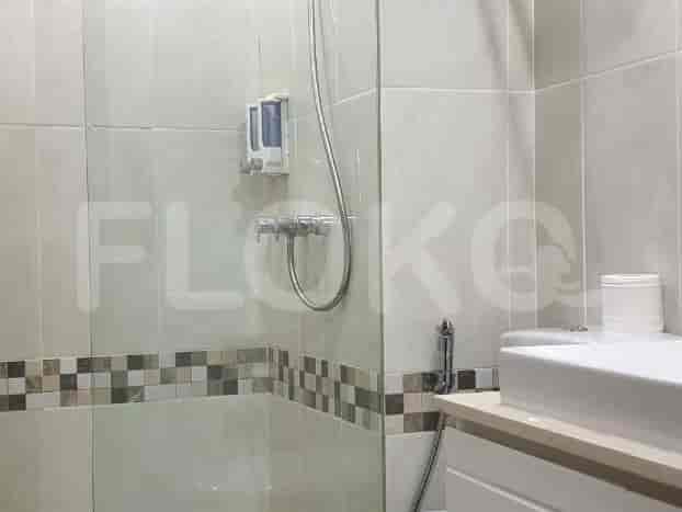 A modern bathroom with a shower and sink.