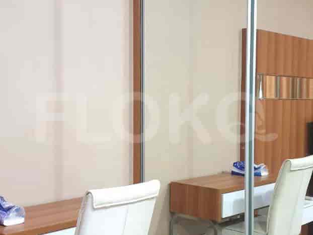 A dressing area with a mirror and a table.