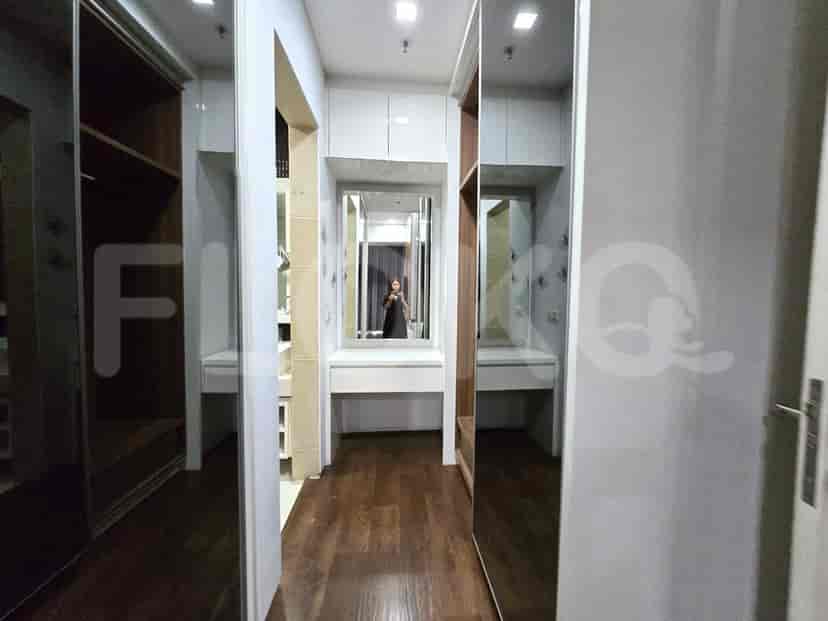 A walk-in closet with mirrored doors and ample storage.