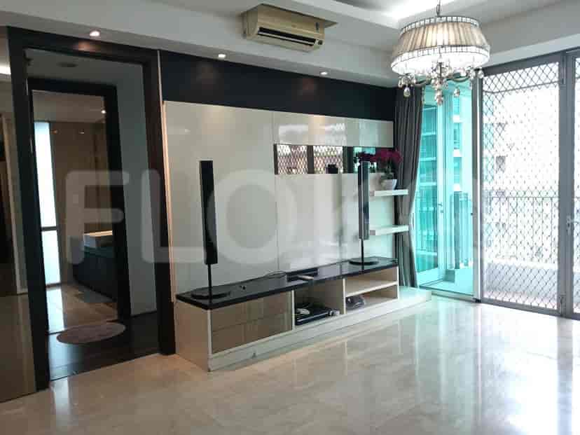 Modern living room with marble floor, built-in entertainment unit, and balcony access.