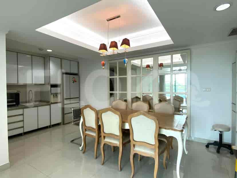 Dining area with a wooden table, chairs, and a decorative ceiling.
