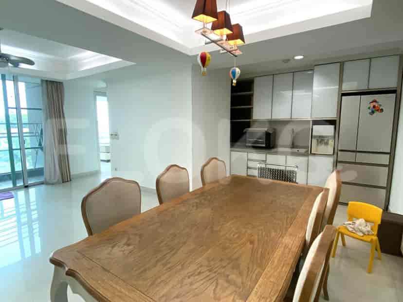 Dining area with a large wooden table and chairs.