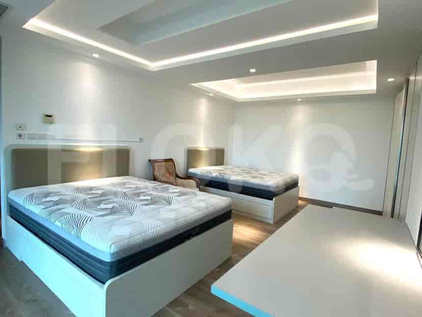 Spacious bedroom with two beds and a simple design.
