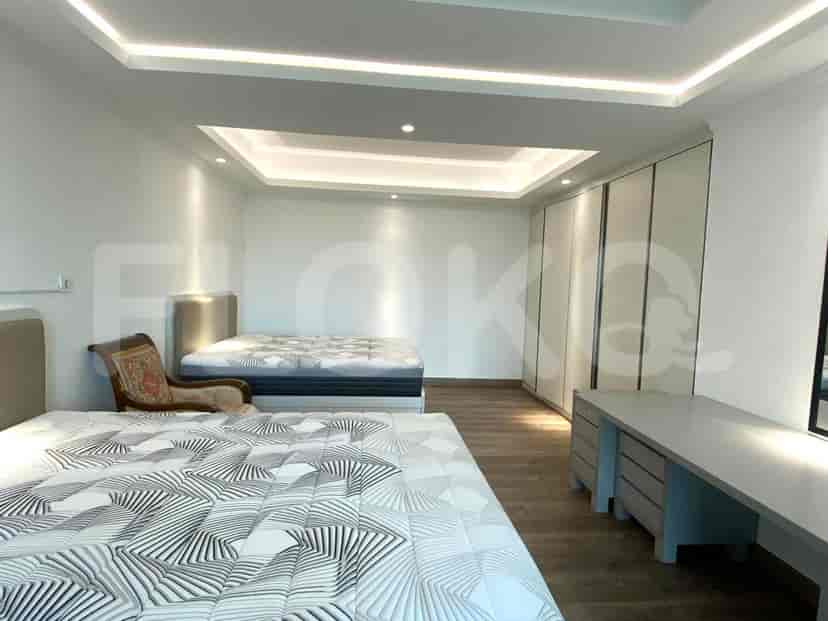 Bedroom with two beds and a large wardrobe.