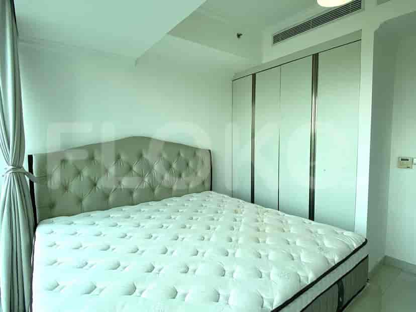 Master bedroom with a large bed and wardrobe.