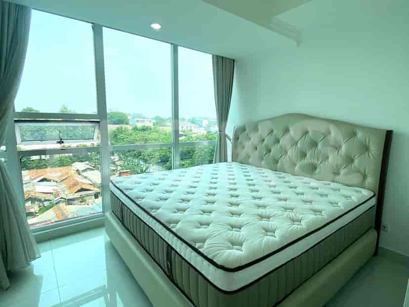 Bedroom with a large bed near a window.