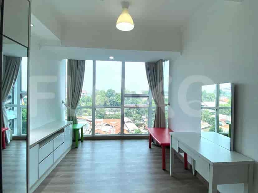 Bedroom with a vanity and windows.