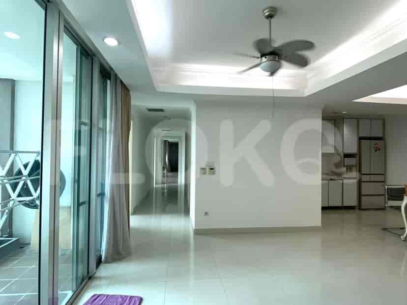 Bright living room with large windows, a dining area, and access to a balcony.