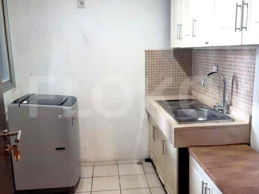 Small kitchen area with a sink and washing machine.