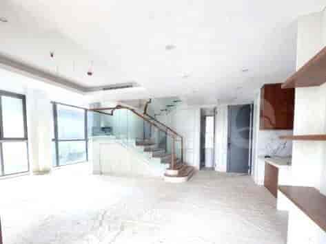 Spacious living area with stairs, large windows, and a modern design.