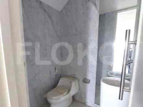 Bathroom with modern fixtures and marble walls.