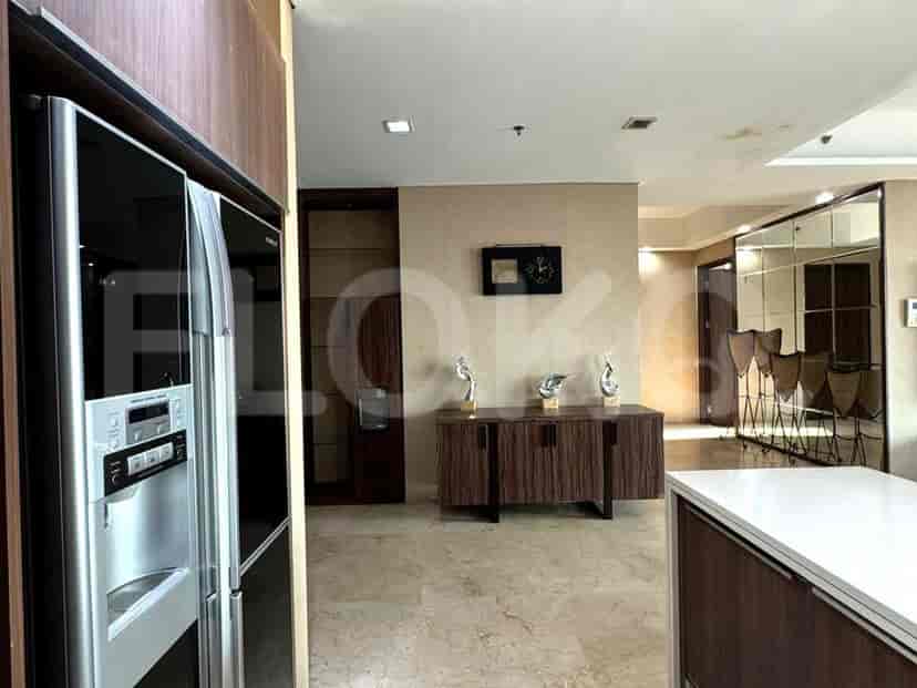 The kitchen featuring a stainless steel fridge.