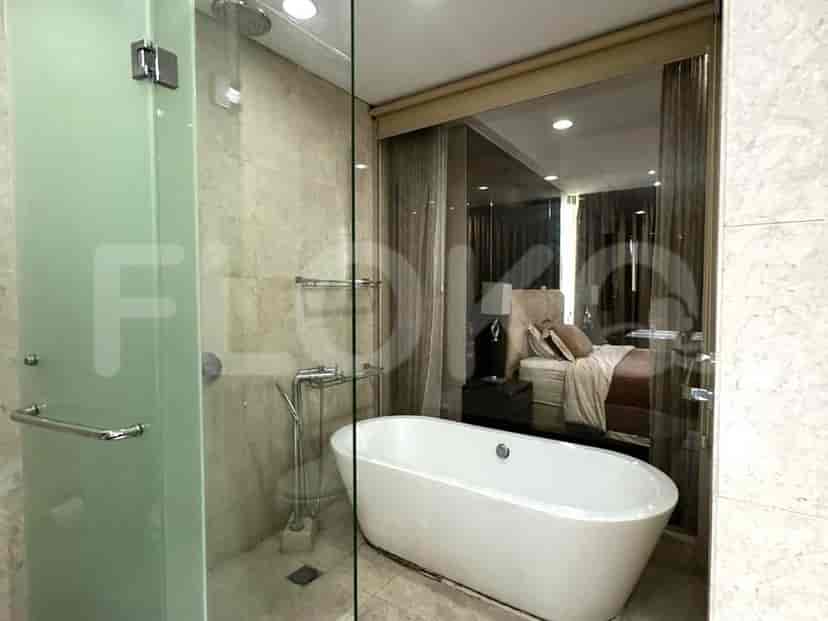 A modern bathroom with a glass-enclosed shower.