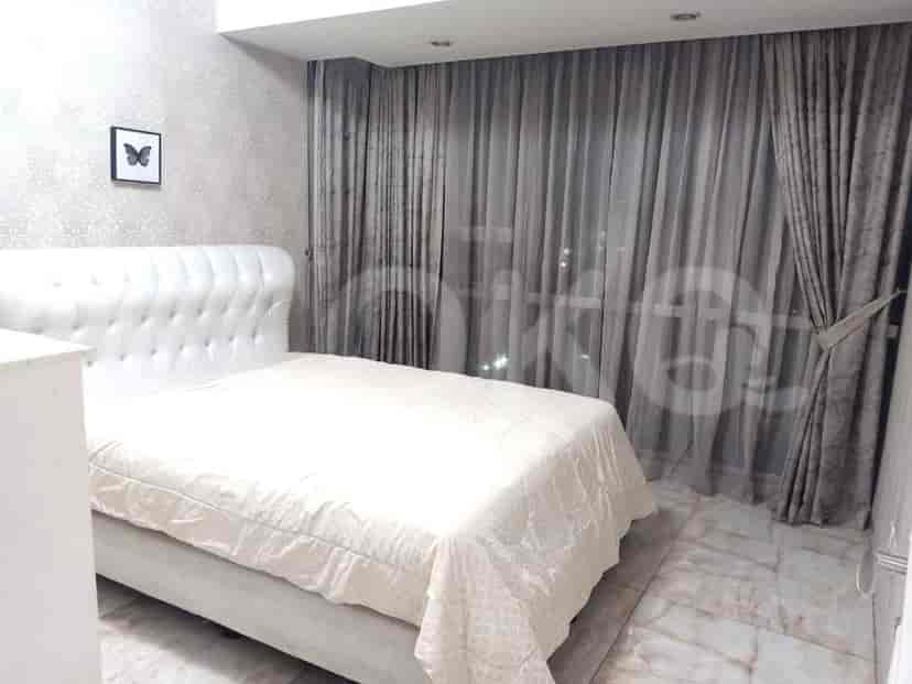 Bedroom with a white bed, curtains, and a framed picture.