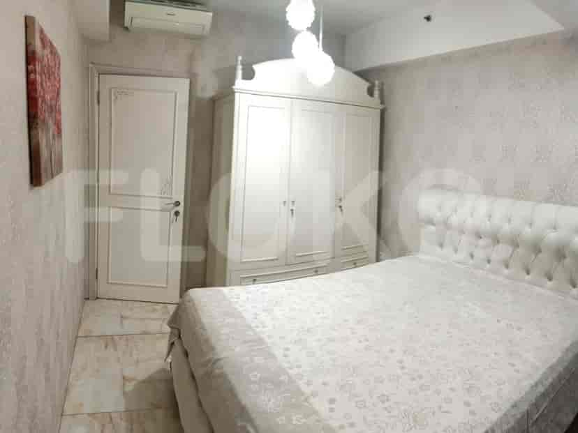 Bedroom with a bed, cabinet, and a window.