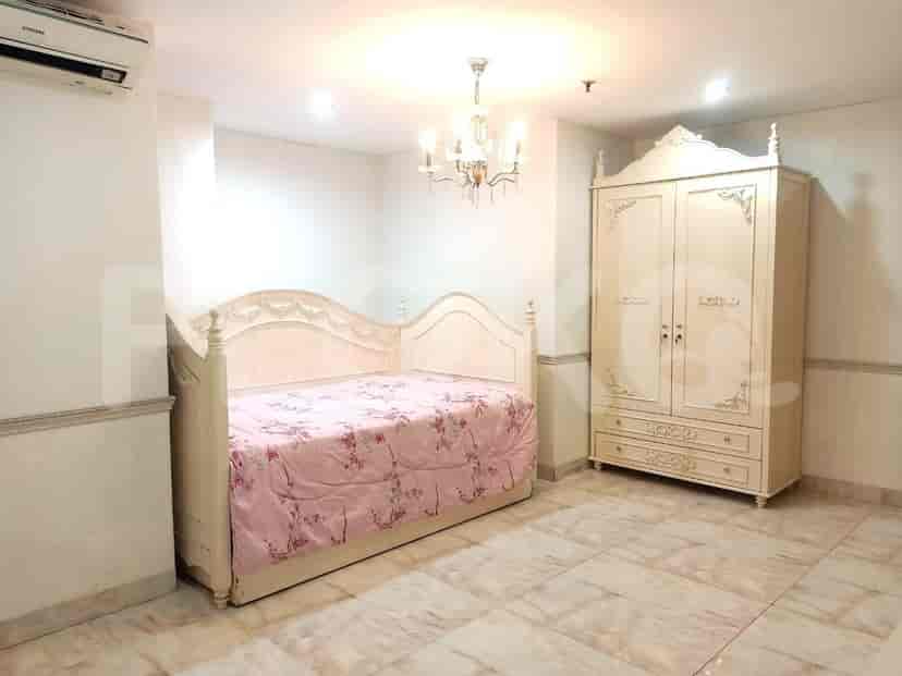 Bedroom with a bed, wardrobe, and chandelier.