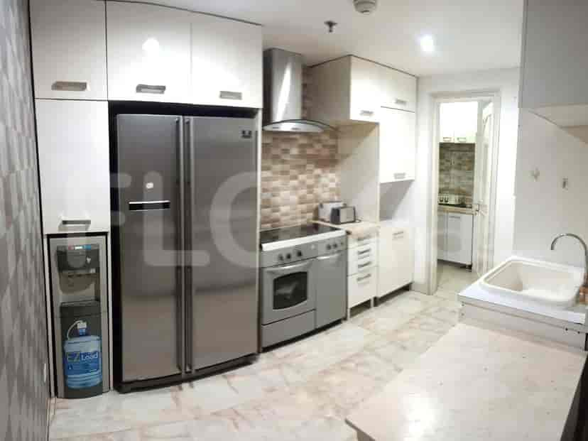 Kitchen with a refrigerator, oven, and cabinets.