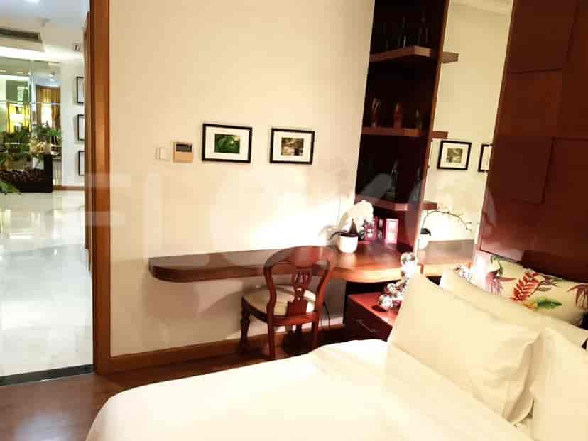 Desk area in a bedroom with a mirror and desk.