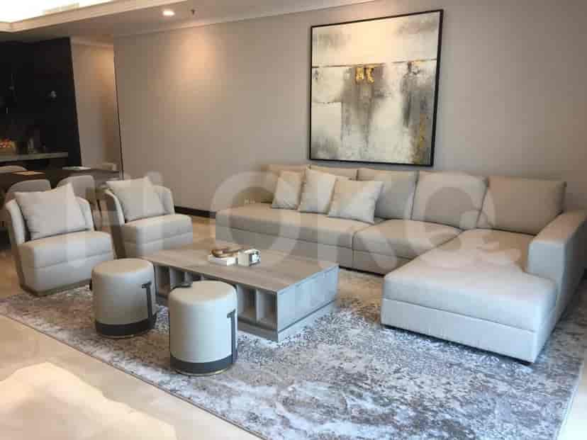 A modern living room with a large sectional sofa, coffee table, and two armchairs.