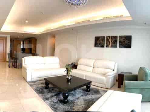 Spacious living room with white sofas, dark wood coffee table, and decorative wall art.