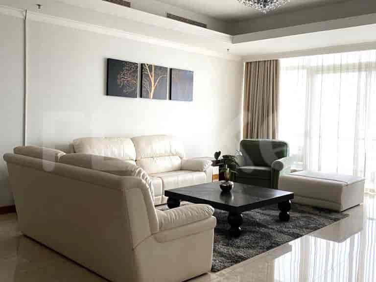 Living room with sofa set and a view from a large window.
