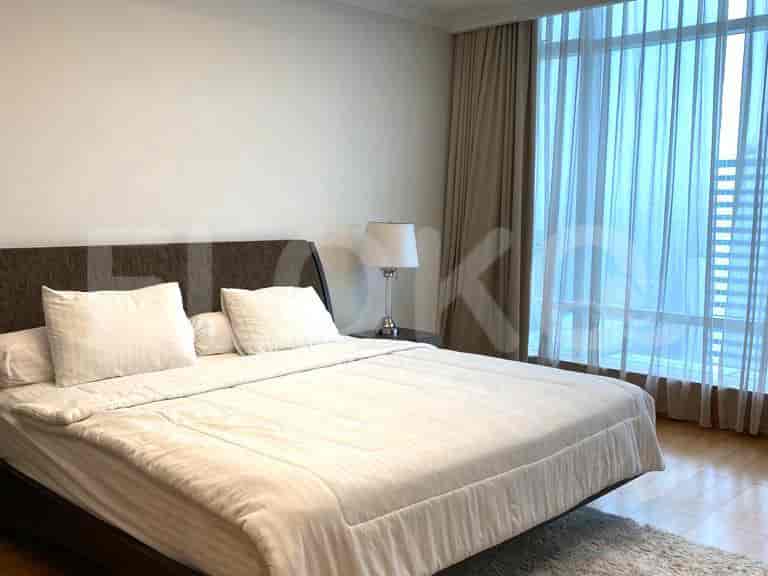 Bedroom with a large bed and curtains.