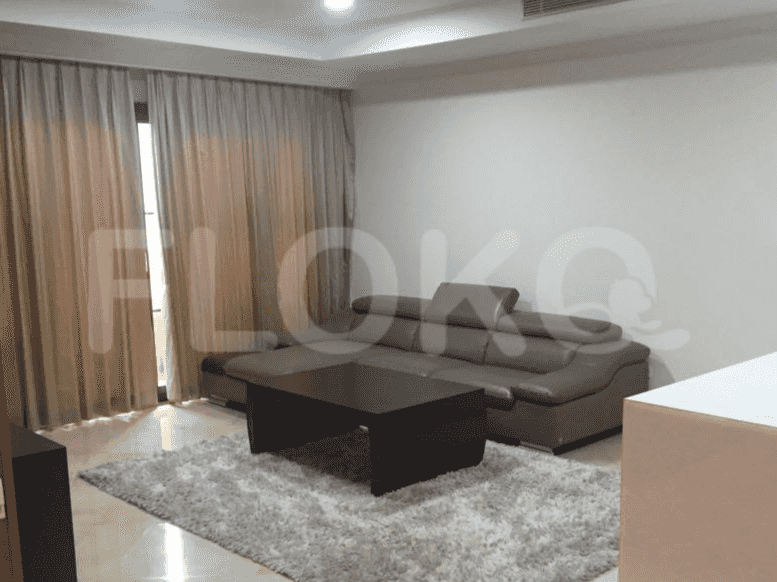 A living room with a grey sofa, coffee table, and floor rug.