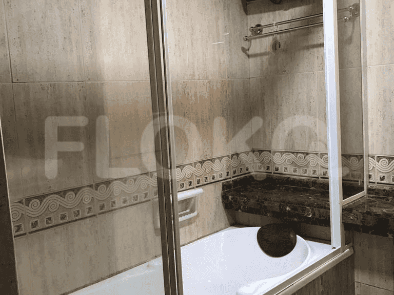 Bathroom with a bathtub and glass shower enclosure.