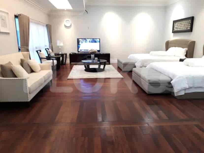 An open-plan living area with two beds, a sofa, and a coffee table.