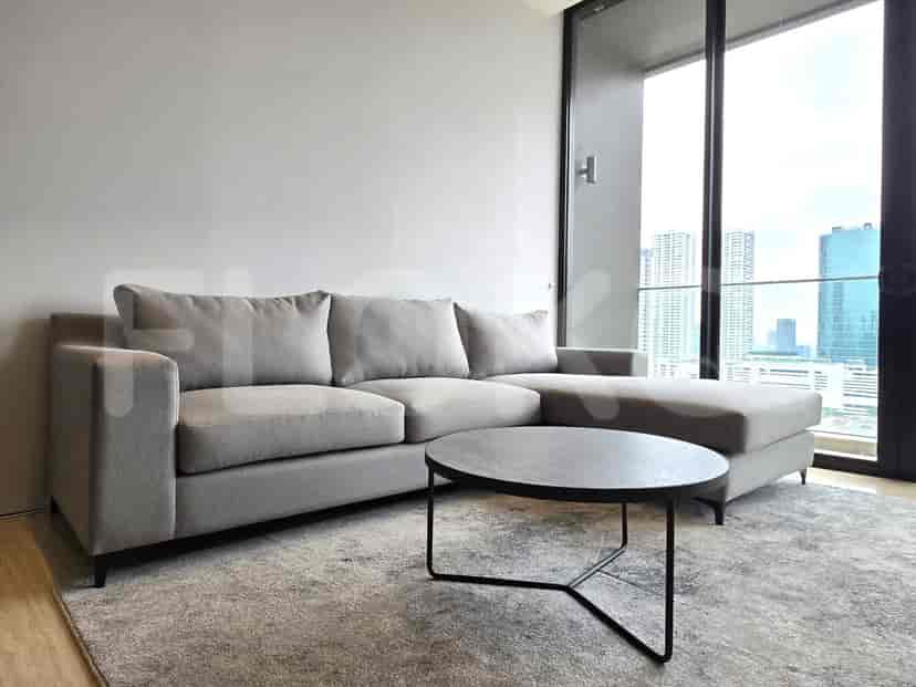 Modern living room with a sectional sofa and city view.