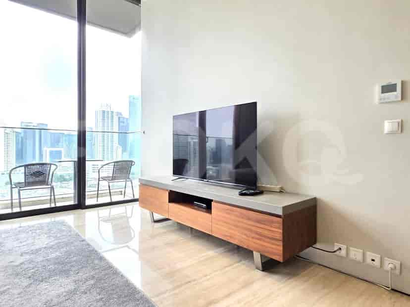 Living room with a TV console and a view of the cityscape.