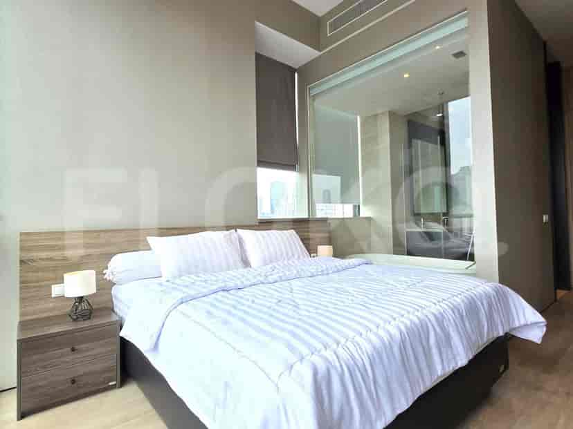 Bedroom with a bed and bathroom with a city view.