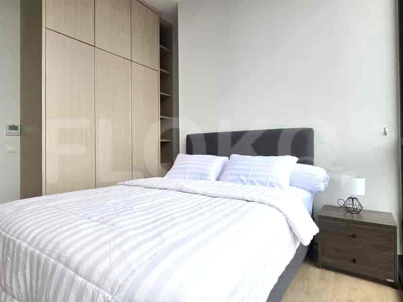 Bedroom with bed, closet and a night stand.