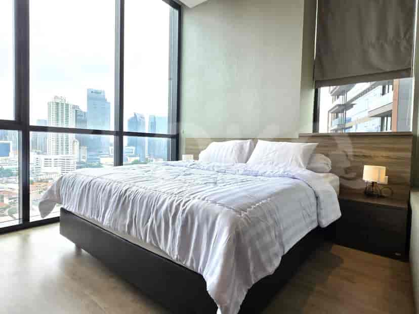 Bedroom with a king bed, nightstand, and a city view.