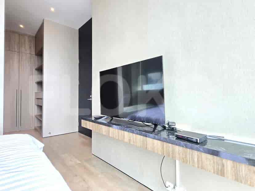 A bedroom showing TV and a closet.