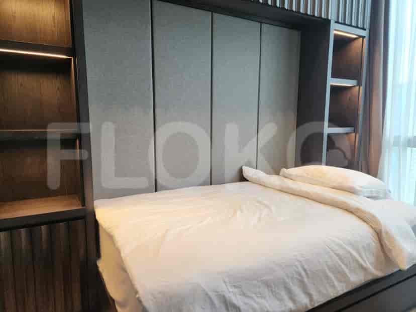 A modern bedroom with a murphy bed and built-in storage.