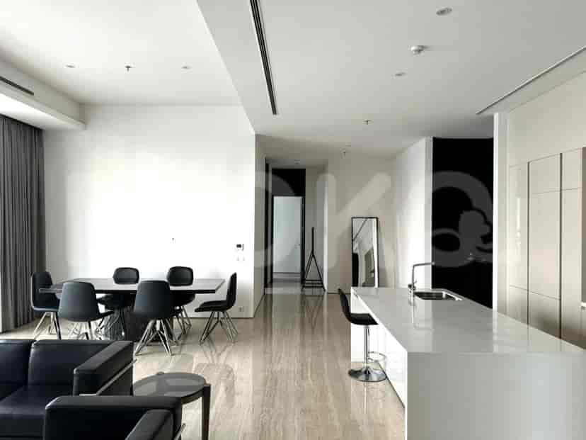 Open-concept kitchen with a breakfast bar and dining table.