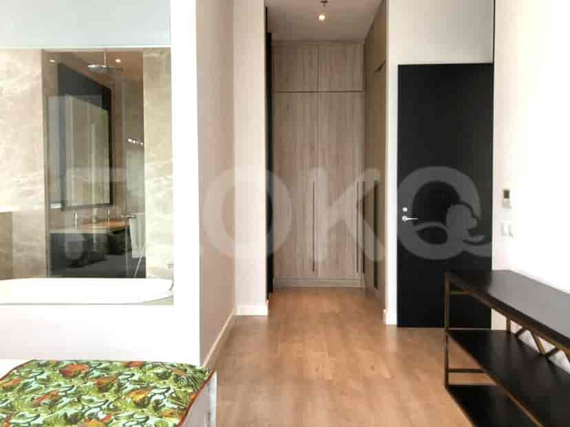 A master bedroom and bathroom showing a bed, built-in closet, and a bathroom.