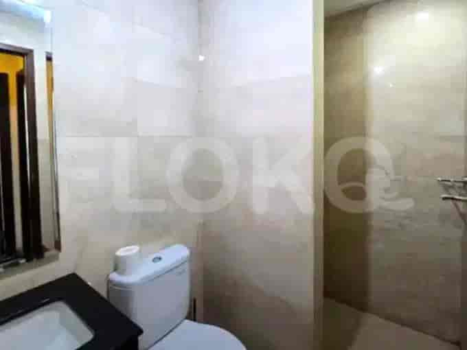 Bathroom with a toilet, sink and shower area.
