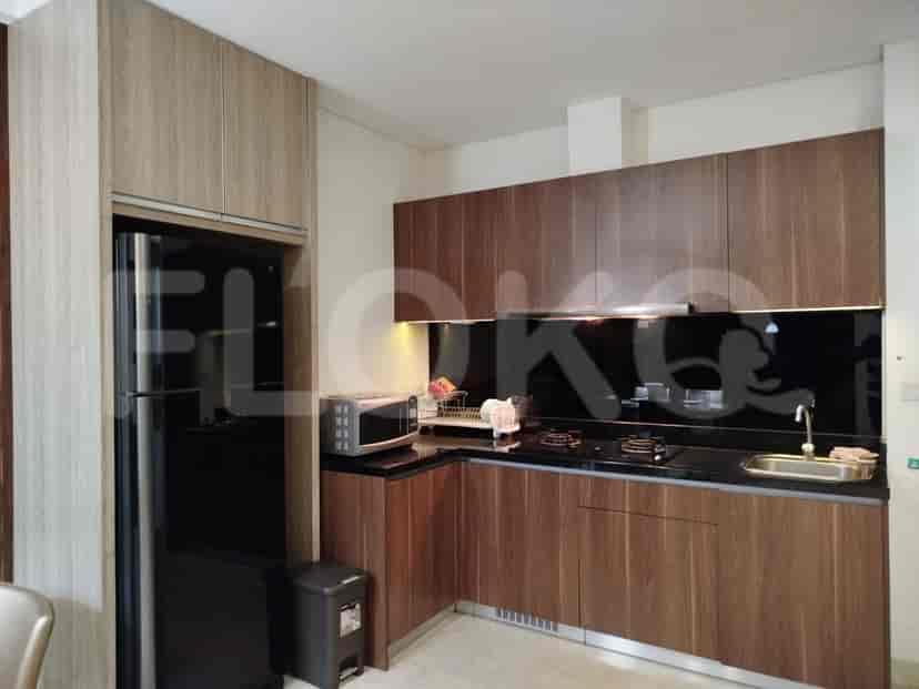 A well-equipped modern kitchen featuring a refrigerator, cabinetry, and appliances.