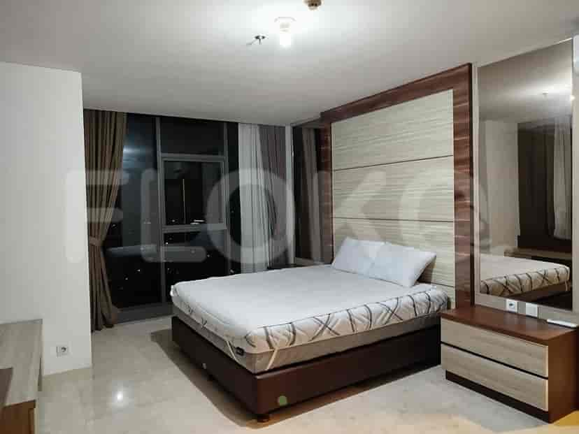 A well-lit bedroom featuring a queen bed, a large window, and a modern design.