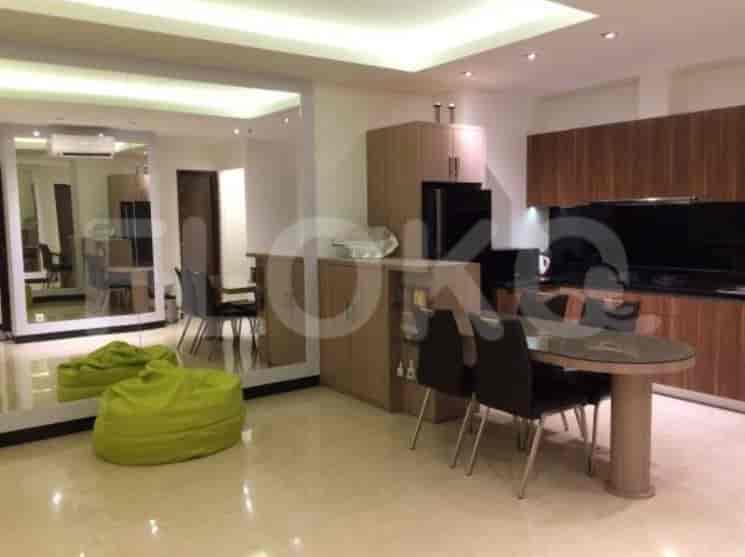 Open kitchen and dining area with modern cabinetry and a round dining table.