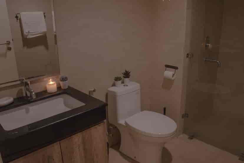 Modern bathroom featuring a sink, toilet, and shower area.