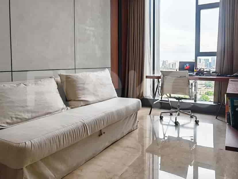 Home office setup with a desk, sofa, and city view.