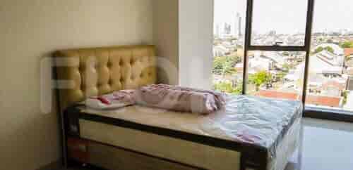 Bedroom with a bed, headboard and a window offering a city view.