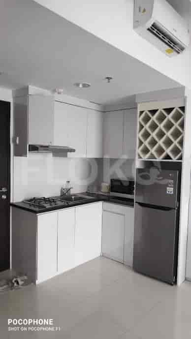 Modern kitchen with white cabinetry and stainless steel appliances.